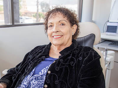 Patient smiles from the dental chair of Glendale Gentle Dentistry in Glendale, AZ